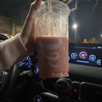 Jamba - a person holding a drink in a car - Juice Bars & Smoothies Near Me - Pomona, California