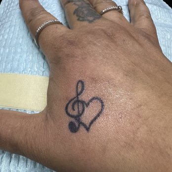 Ink Slingas Tattoo - Music note intertwined with a - Piercing Near Me - Upper Darby, Pennsylvania