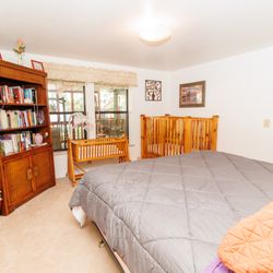 Serenity House Rental - This bedroom has a California King bed, cradle, and crib. It is perfect for a family with books and children's activities available!
