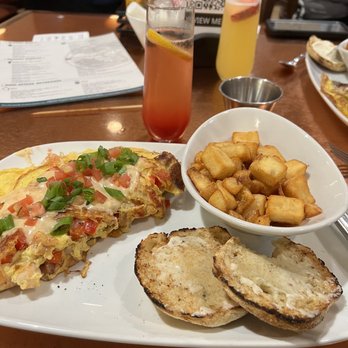 Another Broken Egg Cafe - Mardi Gras omelette with strawberry mimosa - Breakfast & Brunch Near Me - Nashville, Tennessee Another Broken Egg Cafe - Mardi Gras omelette with strawberry mimosa - Breakfast & Brunch Near Me - Nashville, Tennessee