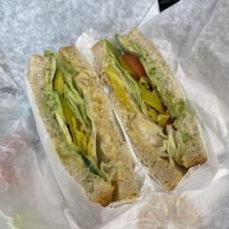 Custom vegan sandwich: Sourdough, (great) hummus, avocado spread (extra $), mustard, lettuce, tomato, cucumber, pepperoncini.