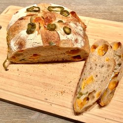 FKN Bread - Jalapeño Cheddar Sourdough Loaf. Spicy and fresh with globs of cheese found throughout the bread.
