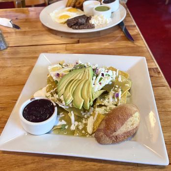 Frontera Sur - Chilaquiles verde...steak, eggs, and plantains in the distance. - Breakfast & Brunch Near Me - Portland, Oregon