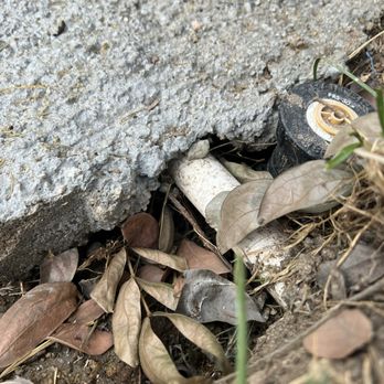 Roman Construction and Landscaping - Less than 1 inch thick around sprinkler line. Even surrounding concrete is no where close to 4 inches. - Landscaping Near Me