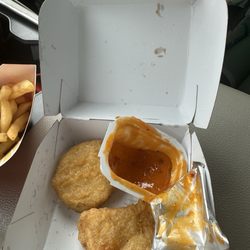 McDonald's - 6 pc. Chicken McNuggets® missing 4 nuggets and a half open sauce to accompany it!