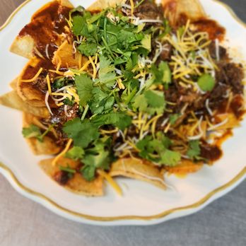 Rosie's Cafe - Lunch Chilaquiles with Birria. Topped with cheese cilantro and onion - Burgers Near Me - Grants, New Mexico Rosie's Cafe - Lunch Chilaquiles with Birria. Topped with cheese cilantro and onion - Burgers Near Me - Grants, New Mexico
