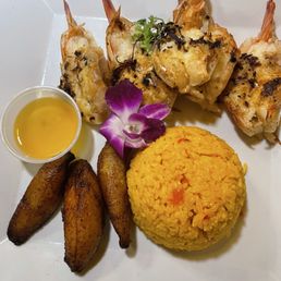 Shrimp grilled to perfection, plantains, rice (white or yellow) black beans in a cup not pictured