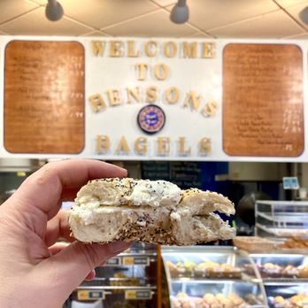 Benson's Bagels - a hand holding a half eaten bagel - Bagels Near Me - Springfield, Massachusetts Benson's Bagels - a hand holding a half eaten bagel - Bagels Near Me - Springfield, Massachusetts