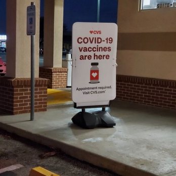 CVS Pharmacy - a sign that reads covidid - 19 vaccines are here - Drugstores Near Me - AUSTIN, Texas