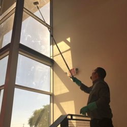 Express Janitorial and Landscaping Services - A member of our crew cleaning the windows