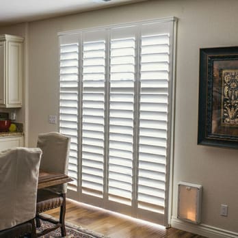 Budget Blinds Serving Livermore/Tracy - Norman Shutters Bifold 180 is the optimum choice for covering your slider patio window. - Shades & Blinds Near Me