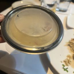 Corn chowder with crab in a to go container. This is a bowl of soup to go.