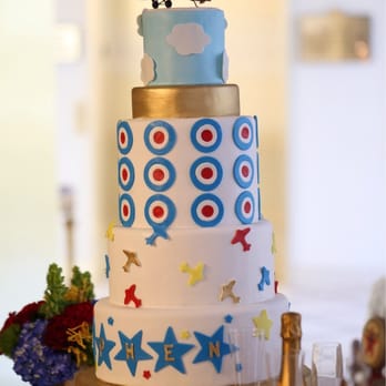 Sweet Escape Cakes - a three tiered cake with a plane on top - Bakeries Near Me Sweet Escape Cakes - a three tiered cake with a plane on top - Bakeries Near Me