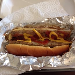 Spicy chicken dog with ketchup & mustard and relish on the bottom.