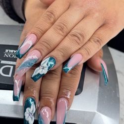 Envy Spa & Nails - A mix of deep teal glitter French tips, marble accents, and 3D acrylic flowers with gemstone centers.
