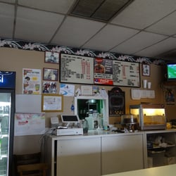 One Stop West Indies Restaurant - The counter where you order (if you look closely, you can see the menu and prices on the board of the back wall).