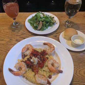 Biltmore Stable Cafe - SHRIMP & GRITS orange flint grits with roasted tomatoes, bacon lardons, and black garlic compound butter and, ROASTED PEAR SALAD. - American Near Me - Asheville, North Carolina Biltmore Stable Cafe - SHRIMP & GRITS orange flint grits with roasted tomatoes, bacon lardons, and black garlic compound butter and, ROASTED PEAR SALAD. - American Near Me - Asheville, North Carolina