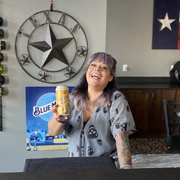 a woman holding a bottle of beer