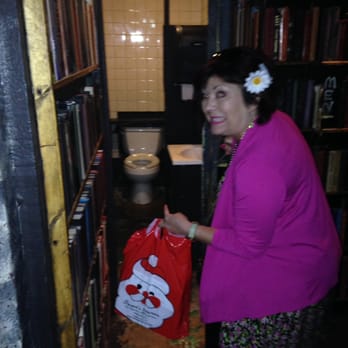 Toulouse Dive Bar - Fake book wall opens up to the bathroom. Thought it was cool and cute. - Dive Bars Near Me - New Orleans, Louisiana