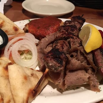 Flaming Cheese Saganaki - Olympic sampler platter with mostly gyro meat and accompanied by the poorly made moussaka - Greek Near Me - Dallas, Texas Flaming Cheese Saganaki - Olympic sampler platter with mostly gyro meat and accompanied by the poorly made moussaka - Greek Near Me - Dallas, Texas