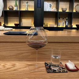 a glass of wine and chopsticks