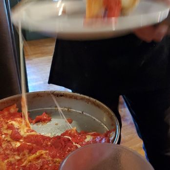 Lou Malnati's Pizzeria - You needed to see that cheese stretch even if the picture is a little blurry! - Pizza Near Me - Buffalo Grove, Illinois