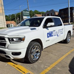 CNC Surveying - White CNC surveying truck.