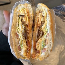 Bacon egg and cheese topped with lettuce ketchup and mayo