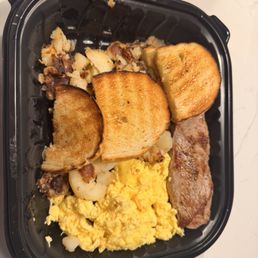 Steak and eggs with sourdough toast and homestyle potatoes Steak and eggs with sourdough toast and homestyle potatoes