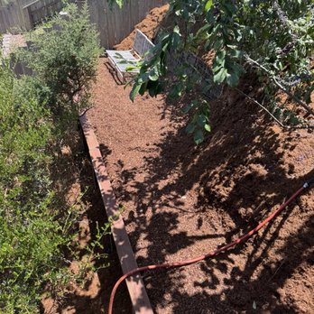 O.R Landscape & Maintenance - New usable layer in our yard after the crew built a retaining wall, flattened, and installed mulch. - Gardeners Near Me O.R Landscape & Maintenance - New usable layer in our yard after the crew built a retaining wall, flattened, and installed mulch. - Gardeners Near Me