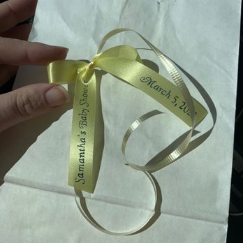 Kerri's Kandies - a hand holding a yellow ribbon - Candy Stores Near Me - Coram, New York