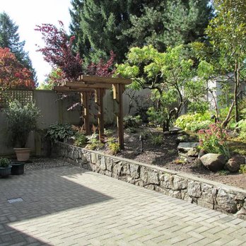 Solid Landscaping - a stone patio with a pergolated arbor - Landscaping Near Me - Vancouver, British Columbia Solid Landscaping - a stone patio with a pergolated arbor - Landscaping Near Me - Vancouver, British Columbia