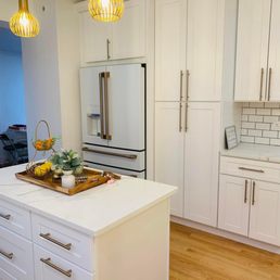 a kitchen with white cabinets and a center island