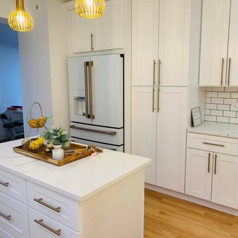 ALS Remodeling - a kitchen with white cabinets and a center island - General Contractors Near Me - Chicago, Illinois