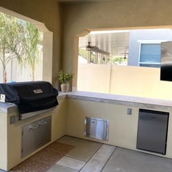 Stucco island with porcelain tile countertop.