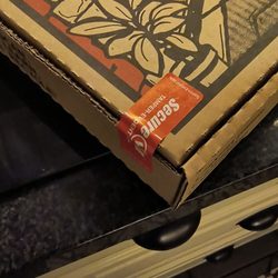 SauceBros Pizza - Tamper stickers on both corners of the box.