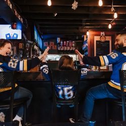 SOHA Bar and Grill - Bar area with three happy customers