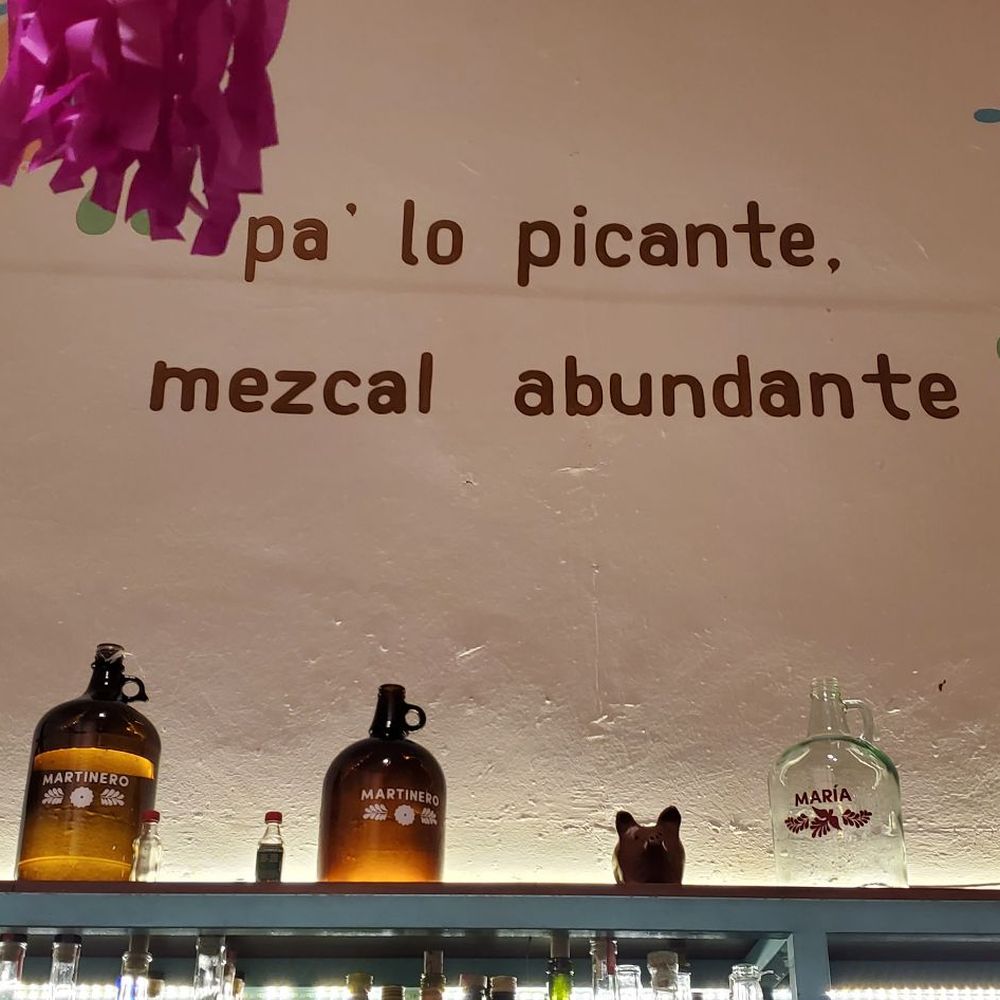 Casa Taviche - Bar wall at the entrance. Saying reads, for spicy food, lots of mezcal. - Mexican Near Me - Oaxaca, OAX Casa Taviche - Bar wall at the entrance. Saying reads, for spicy food, lots of mezcal. - Mexican Near Me - Oaxaca, OAX