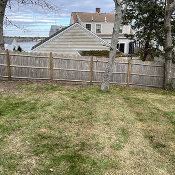 Integrity First Landscaping - a fenced yard with a house in the background - Landscaping Near Me
