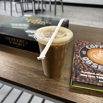 Monkey Dog Coffee - a cup of coffee and a book on a table - Coffee & Tea Near Me - Clovis, California Monkey Dog Coffee - a cup of coffee and a book on a table - Coffee & Tea Near Me - Clovis, California