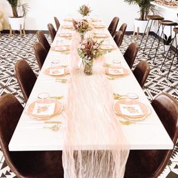 Parlor's tables and chairs design compliment the fun floor tile and space so beautifully!