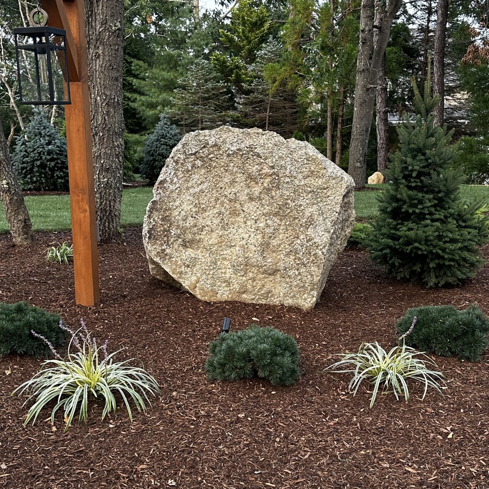 a large rock in a garden a large rock in a garden