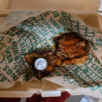 Wingstop - Two thighs!?! Yep. Orange Szechuan thighs. Yes that is a Quarter on top. - Chicken Wings Near Me - Jacksonville, North Carolina Wingstop - Two thighs!?! Yep. Orange Szechuan thighs. Yes that is a Quarter on top. - Chicken Wings Near Me - Jacksonville, North Carolina