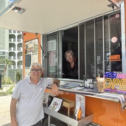 The owners in the coffee truck with my drink on the side. The owners in the coffee truck with my drink on the side.