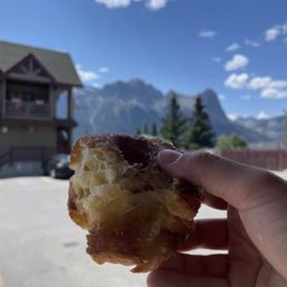 a hand holding a pastry a hand holding a pastry