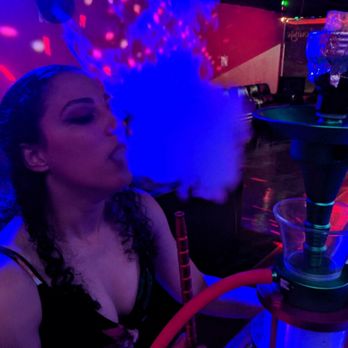 Club Phoenix Hookah Lounge - a woman smoking a hookah - Hookah Bars Near Me - Jacksonville, North Carolina Club Phoenix Hookah Lounge - a woman smoking a hookah - Hookah Bars Near Me - Jacksonville, North Carolina