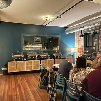 Natty Greene's Brewpub - a group of people sitting around a table - Breweries Near Me - Greensboro, North Carolina