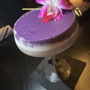 Renny's - a purple cocktail with a flower on top - Bars Near Me - Dallas, Texas
