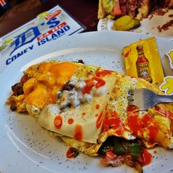 Stuffed with Burger Onion n Peppers topped with 2 Cheese's with Grits the Downriver Omelette Wonderful