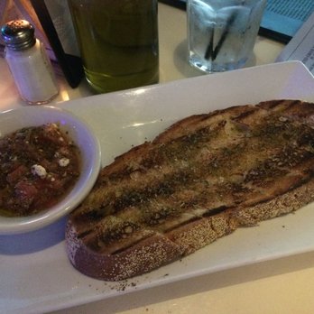 Poseidon - complimentary homemade bread (olive oil flat bread) w/ tomato, feta and olive oil sauce on the side - Greek Near Me - Miami Beach, Florida Poseidon - complimentary homemade bread (olive oil flat bread) w/ tomato, feta and olive oil sauce on the side - Greek Near Me - Miami Beach, Florida